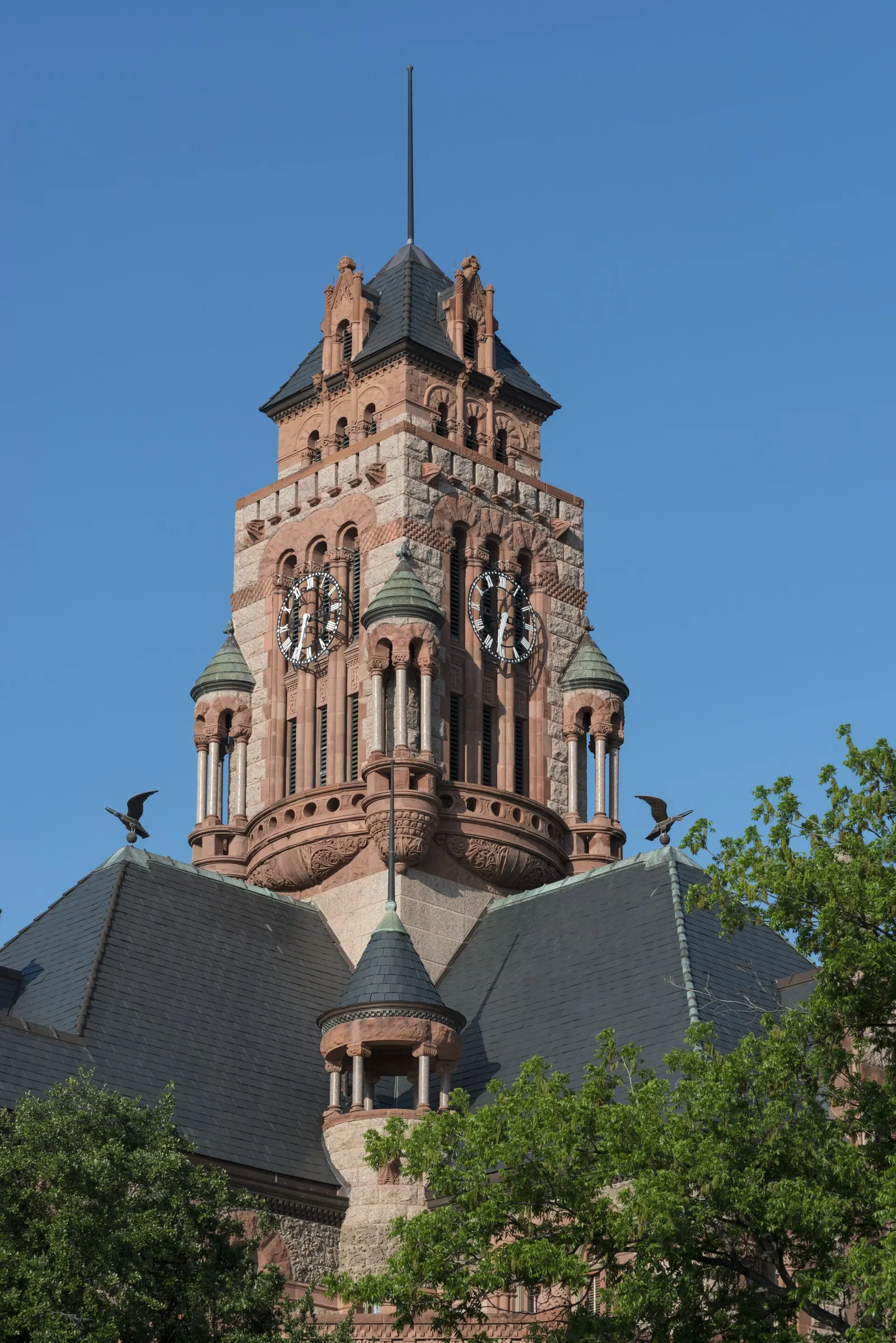 The clock tower of the 1897 Ellis County Courthouse in Waxahachie against a blue sky